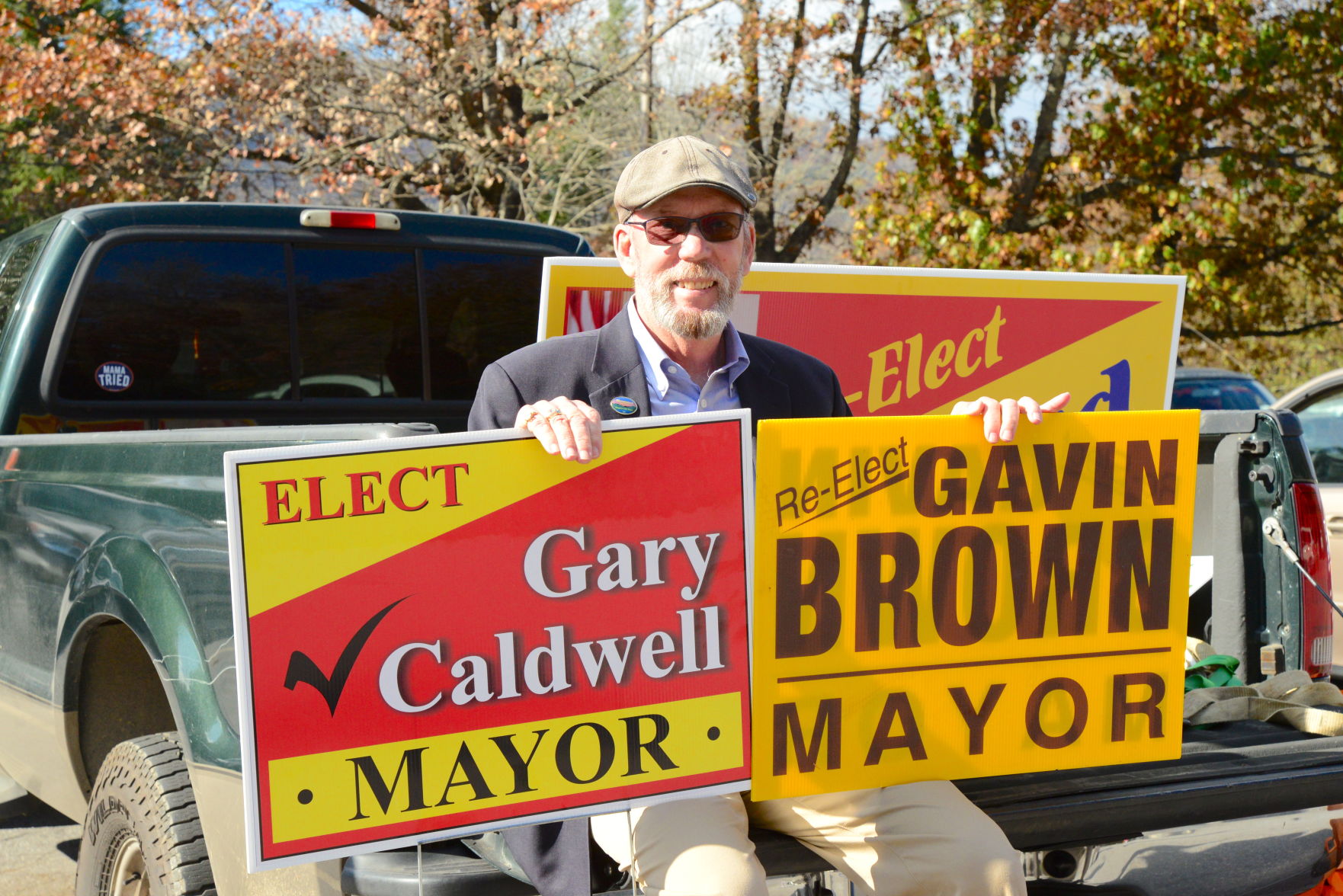 gavin brown at polls with two signs.JPG
